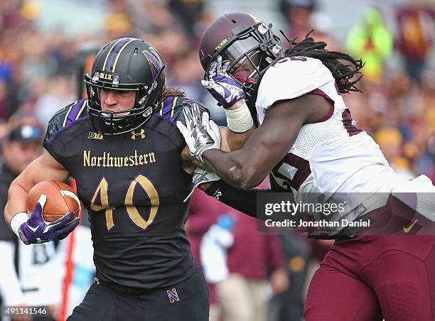 Dan Vitale of the Northwestern Wildcats fights off De'Vondre Campbell of the Minnesota Golden Gophers at Ryan Field on October 3, 2015 in Evanston,...