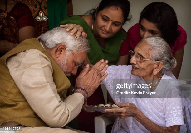 Leader Narendra Modi is blessed by his mother Heeraben Modi on her front porch after seeking her blessing on May 16, 2014 in Ahmedabad, India. Early...
