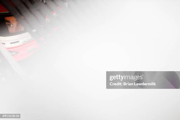 Austin Dillon, driver of the DOW Chevrolet, sits in his car during practice for the NASCAR Sprint Cup Series AAA 400 at Dover International Speedway...