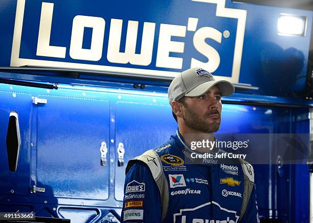 Jimmie Johnson, driver of the Lowe's Chevrolet, stands in the garage area during practice for the NASCAR Sprint Cup Series AAA 400 at Dover...