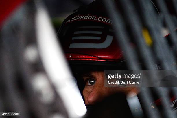 Jeff Gordon, driver of the AARP Member Advantages Chevrolet, sits in his car in the garage area during practice for the NASCAR Sprint Cup Series AAA...