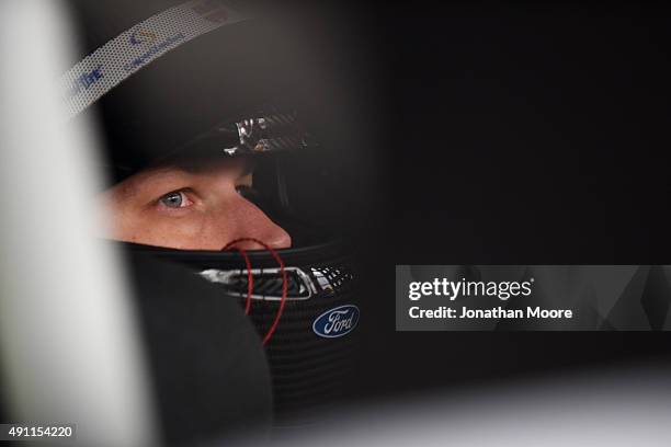 Brad Keselowski, driver of the Wurth Ford, sits in his car in the garage area during practice for the NASCAR Sprint Cup Series AAA 400 at Dover...