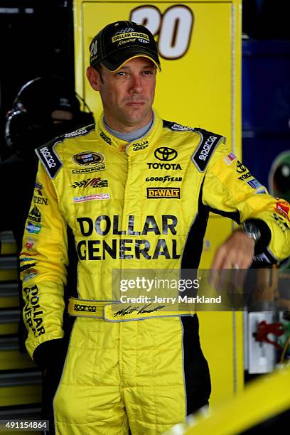 Matt Kenseth, driver of the Dollar General Toyota, looks on in the garage area during practice for the NASCAR Sprint Cup Series AAA 400 at Dover...