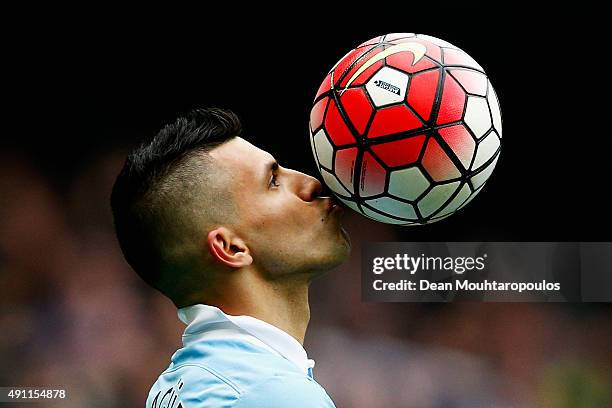 Sergio Aguero of Manchester City kisses the ball to celebrate a goal and his hat-trick during the Barclays Premier League match between Manchester...
