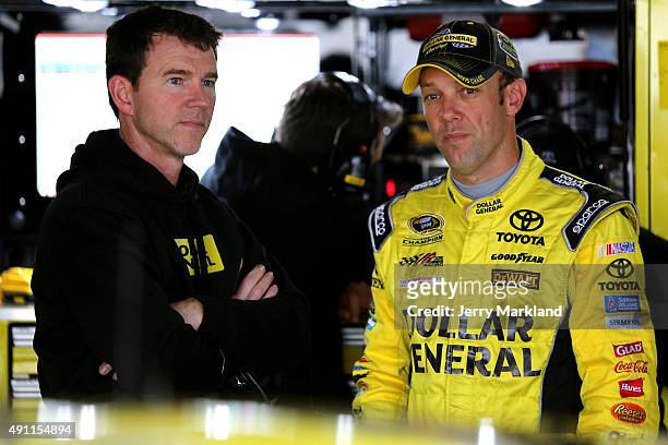 Matt Kenseth, driver of the Dollar General Toyota, left, talks with crew chief Jason Ratcliff in the garage area during practice for the NASCAR...