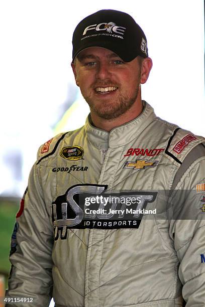 Justin Allgaier, driver of the Fraternal Order of Eagles Chevrolet, looks on in the garage area during practice for the NASCAR Sprint Cup Series AAA...