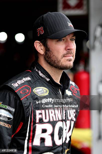 Martin Truex Jr., driver of the Furniture Row/Visser Precision Chevrolet, looks on in the garage area during practice for the NASCAR Sprint Cup...