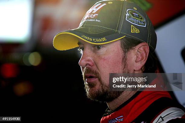 Kurt Busch, driver of the Haas Automation Chevrolet, looks on in the garage area during practice for the NASCAR Sprint Cup Series AAA 400 at Dover...