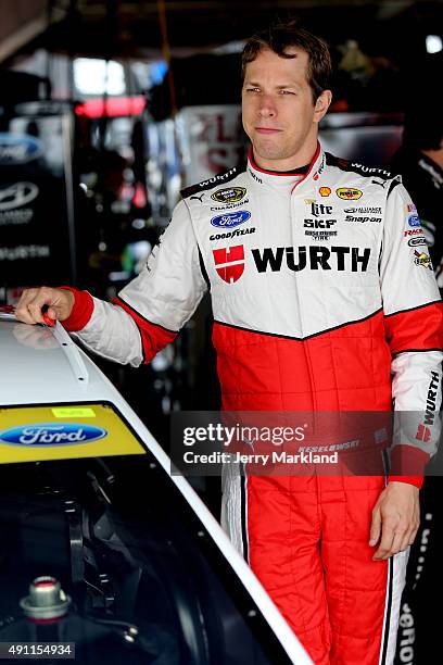 Brad Keselowski, driver of the Wurth Ford, looks on in the garage area during practice for the NASCAR Sprint Cup Series AAA 400 at Dover...