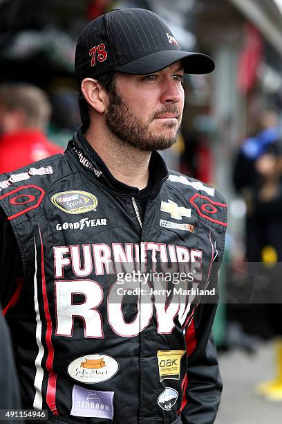 Martin Truex Jr., driver of the Furniture Row/Visser Precision Chevrolet, looks on in the garage area during practice for the NASCAR Sprint Cup...