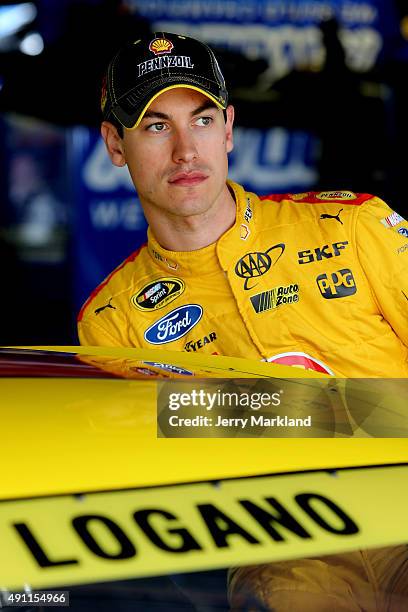 Joey Logano, driver of the Shell Pennzoil Ford, climbs into his car in the garage area during practice for the NASCAR Sprint Cup Series AAA 400 at...