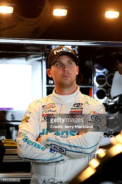 Denny Hamlin, driver of the FedEx Office Toyota, looks on in the garage area during practice for the NASCAR Sprint Cup Series AAA 400 at Dover...