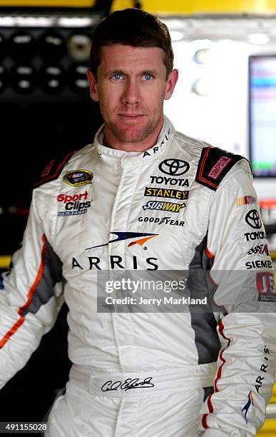 Carl Edwards, driver of the ARRIS Toyota, looks on in the garage area during practice for the NASCAR Sprint Cup Series AAA 400 at Dover International...