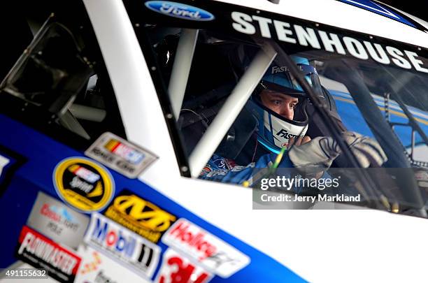 Ricky Stenhouse Jr., driver of the Fastenal Ford, prepares his equipment in his car during practice for the NASCAR Sprint Cup Series AAA 400 at Dover...