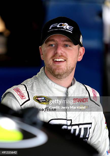 Justin Allgaier, driver of the Fraternal Order of Eagles Chevrolet, looks on in the garage area during practice for the NASCAR Sprint Cup Series AAA...