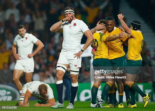 Chris Robshaw and Tom Wood of England react as Bernard Foley of Australia celebrates scoring their first try with team mates during the 2015 Rugby...