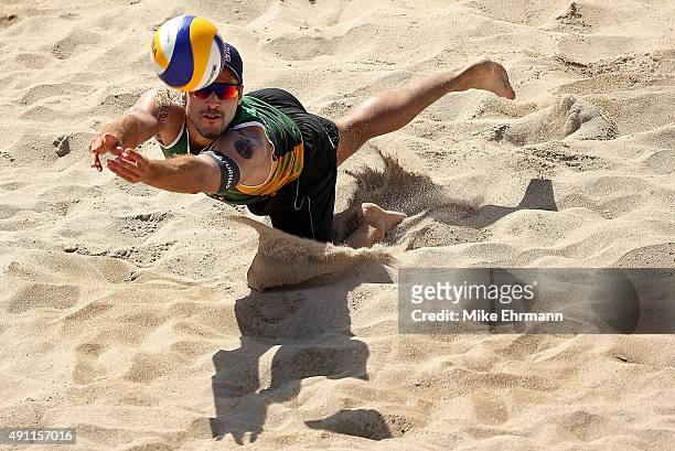 Evandro Gonvlaves of Brazil plays a shot during a match against Cerutti Alison and Oscar Schmidt Bruno of Brazil at the FIVB Fort Lauderdale Swatch...