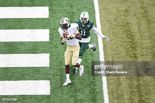 Erren Wilson of the UCF Knights catches a pass for a touchdown in front of Dedrick Shy of the Tulane Green Wave during the fourth quarter of a game...