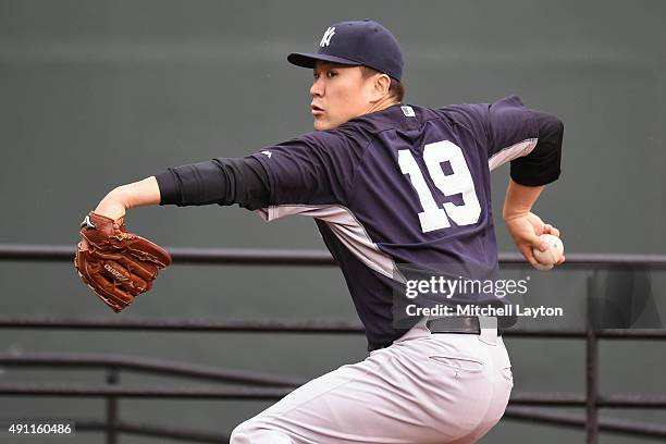 Masahiro Tanaka of the New York Yankees throws a bullpen session before game two of a baseball game against the Baltimore Orioles at Oriole Park at...