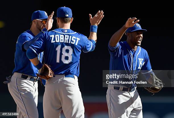 Paulo Orlando, Ben Zobrist and Lorenzo Cain of the Kansas City Royals celebrate a win of the game against the Minnesota Twins on October 3, 2015 at...