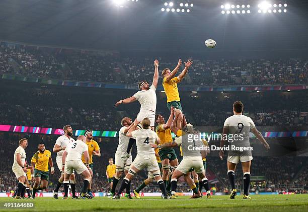 Michael Hooper of Australia wins the line out ball from Tom Wood of England during the 2015 Rugby World Cup Pool A match between England and...