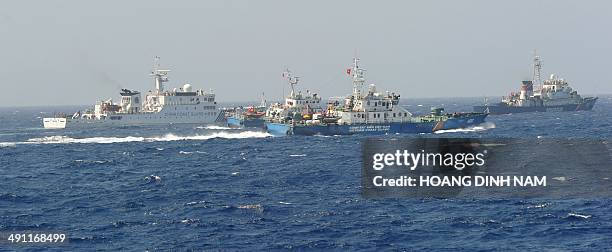 This picture taken on May 15, 2014 shows a Chinese coast guard ship being blocked by three Vietnamese coast guard vessels near China's oil drilling...