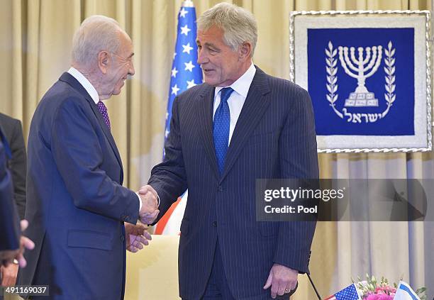 Defense Secretary Chuck Hagel shakes hands with Israeli President Shimon Peres at the prime minister's office on May 16, 2014 in Jerusalem, Israel....