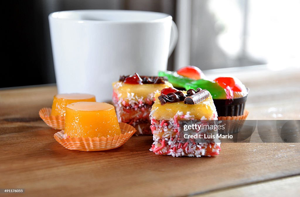 Small sweet cakes with cup of coffee