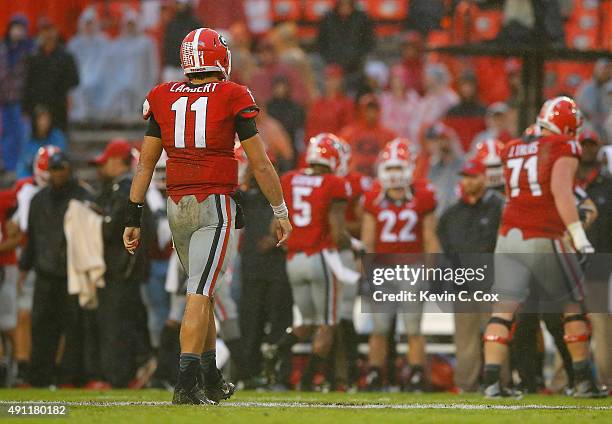 Greyson Lambert of the Georgia Bulldogs walks off the field after a failed series against the Alabama Crimson Tide at Sanford Stadium on October 3,...