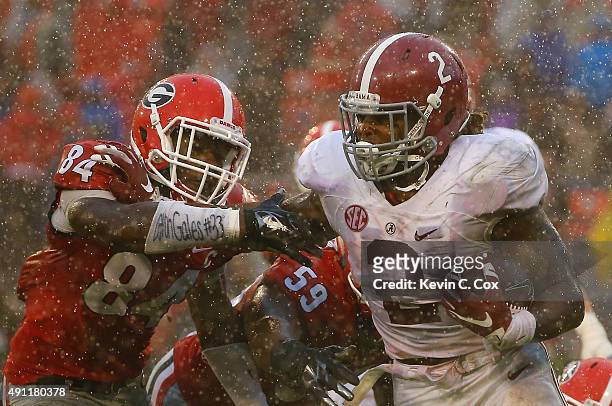 Derrick Henry of the Alabama Crimson Tide tries to break a tackle by Leonard Floyd of the Georgia Bulldogs at Sanford Stadium on October 3, 2015 in...