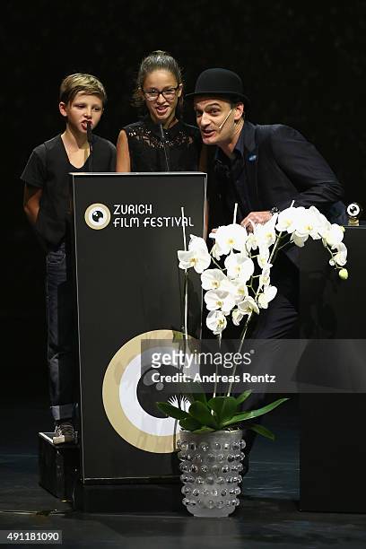 Two children and actor Anatole Taubman speak onstage at the Award Night Ceremony during the Zurich Film Festival on October 3, 2015 in Zurich,...