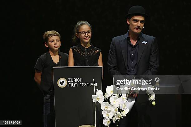 Two children and actor Anatole Taubman speak onstage at the Award Night Ceremony during the Zurich Film Festival on October 3, 2015 in Zurich,...