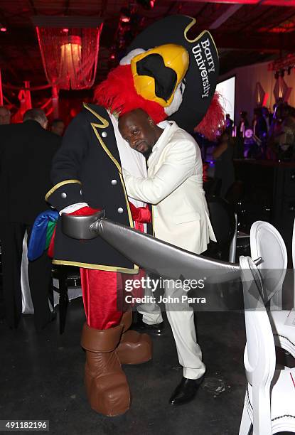 Wyclef Jean poses with mascot at Barry University's 75th Anniversary birthday bash at Soho Studios on October 3, 2015 in Miami, Florida.