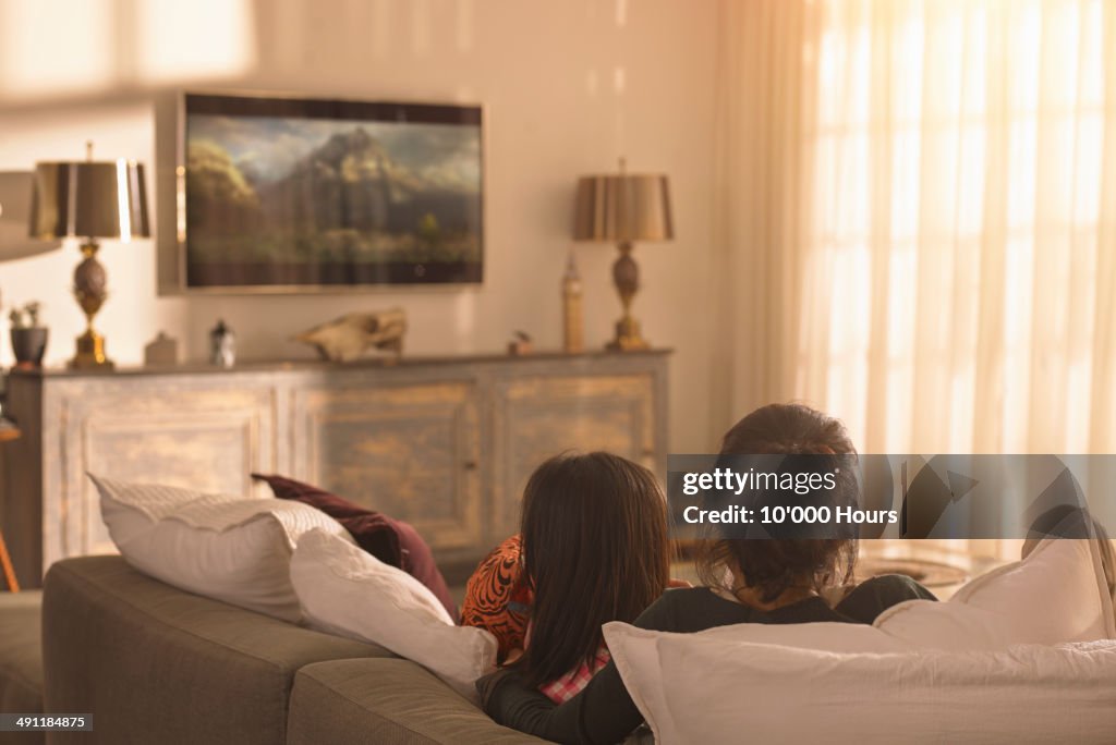 Mother and daughter watching television
