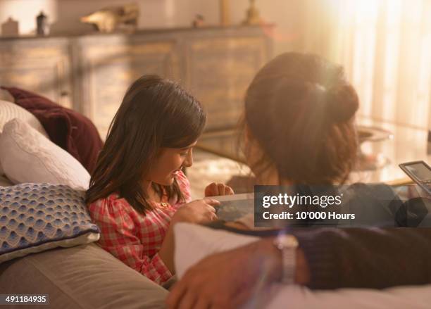 a girl showing her parents something on an tablet computer - indian couple at home imagens e fotografias de stock