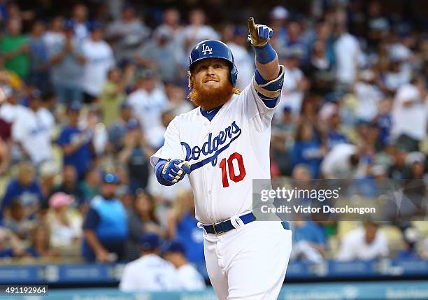Justin Turner of the Los Angeles Dodgers points to the stands after hitting a solo homerun to center field in the first inning against the San Diego...
