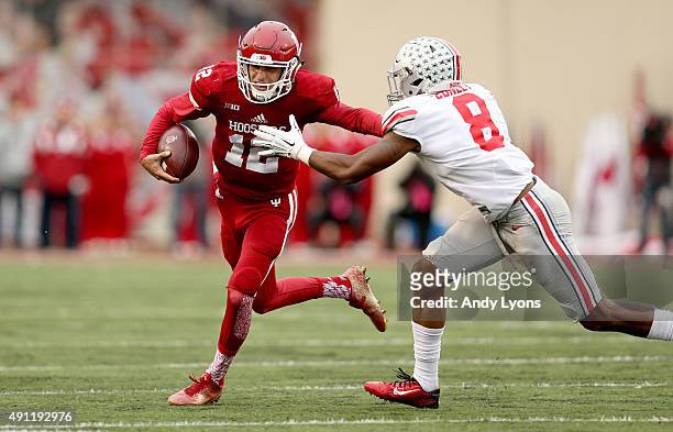 Zander Diamont of the Indiana Hoosiers runs with the ball while defended by Gareon Conley of the Ohio State Buckeyes at Memorial Stadium on October...