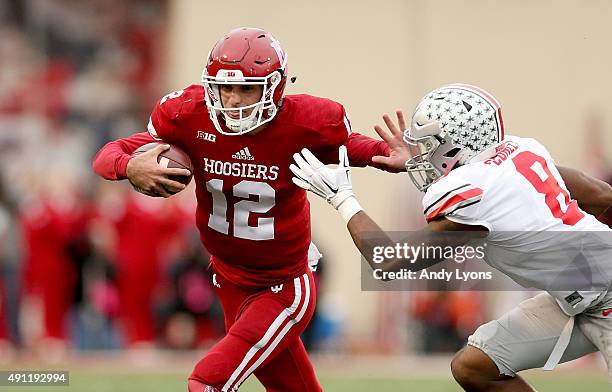 Zander Diamont of the Indiana Hoosiers runs with the ball while defended by Gareon Conley of the Ohio State Buckeyes at Memorial Stadium on October...