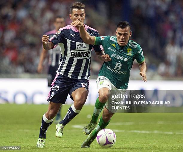 Edwin Cardona of Monterrey vies for the ball with Aldo Rocha of Leon during the Mexican Apertura 2015 tournament football match in Monterrey, Mexico...