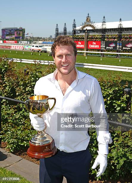 Campbell Brown poses with the Emirates Melbourne Cup in the Triple M Enclosure during Turnbull Stakes Day at Flemington Racecourse on October 4, 2015...