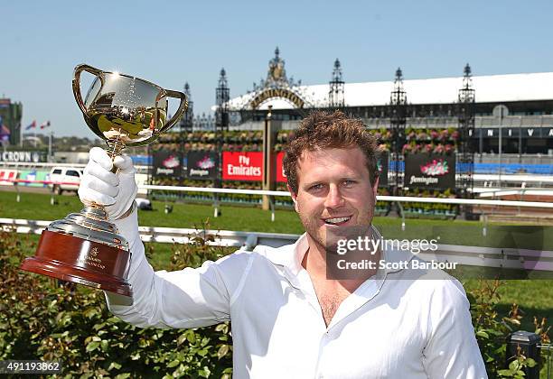 Campbell Brown poses with the Emirates Melbourne Cup in the Triple M Enclosure during Turnbull Stakes Day at Flemington Racecourse on October 4, 2015...