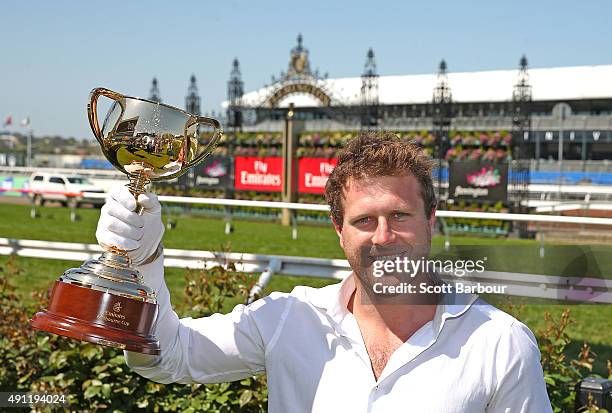 Campbell Brown poses with the Emirates Melbourne Cup in the Triple M Enclosure during Turnbull Stakes Day at Flemington Racecourse on October 4, 2015...