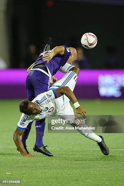 Aurelien Collin of Orlando City SC is kicked in the face by Didier Drogba of Montreal Impact during an MLS soccer match between the Montreal Impact...