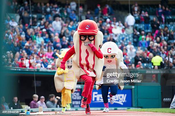 Cleveland Indians mascots Catchup, Mustard and Onion run the hotdog race during the fifth inning of the game between the Detroit Tigers and Cleveland...