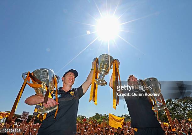 Alastair Clarkson the coach and Luke Hodge the captian of the Hawks pose with the 2013, 2014 and 2015 premiership trophies during the Hawthorn Hawks...