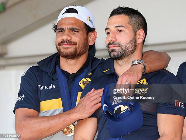 Cyril Rioli of the Hawks puts his arm around Paul Puopolo during the Hawthorn Hawks AFL Grand Final fan day at Glenferrie Oval on October 4, 2015 in...