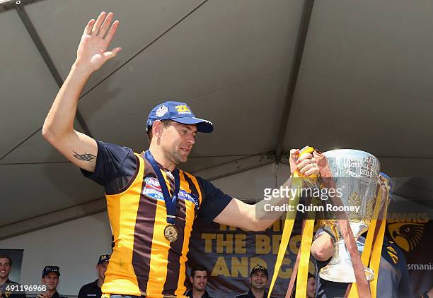 Luke Hodge of the Hawks brings in the Premiership Trophy during the Hawthorn Hawks AFL Grand Final fan day at Glenferrie Oval on October 4, 2015 in...