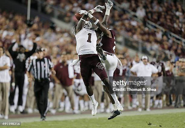 De'Runnya Wilson of the Mississippi State Bulldogs has his pass broken up by Brandon Williams of the Texas A&M Aggies in the second half on October...