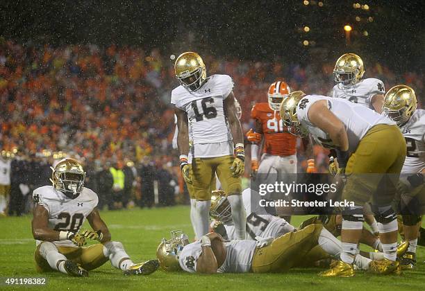 DeShone Kizer of the Notre Dame Fighting Irish and teammate C.J. Prosise sit on the field after a goal line stop by the defense of the Clemson Tigers...