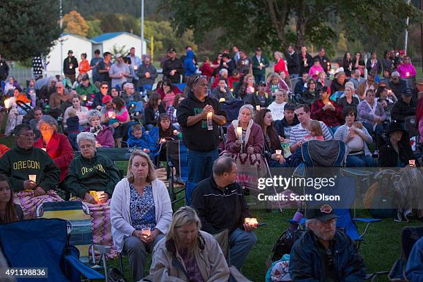 Residents of Douglas County attend a prayer service and candlelight vigil at River Bend Park to remember the victims of the mass shooting at Umpqua...